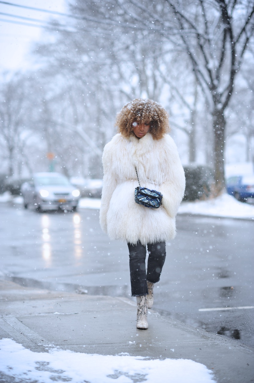 Karen Blanchard wearing a mongolian fur coat and Free People snake print ankle boots with black cropped jeans