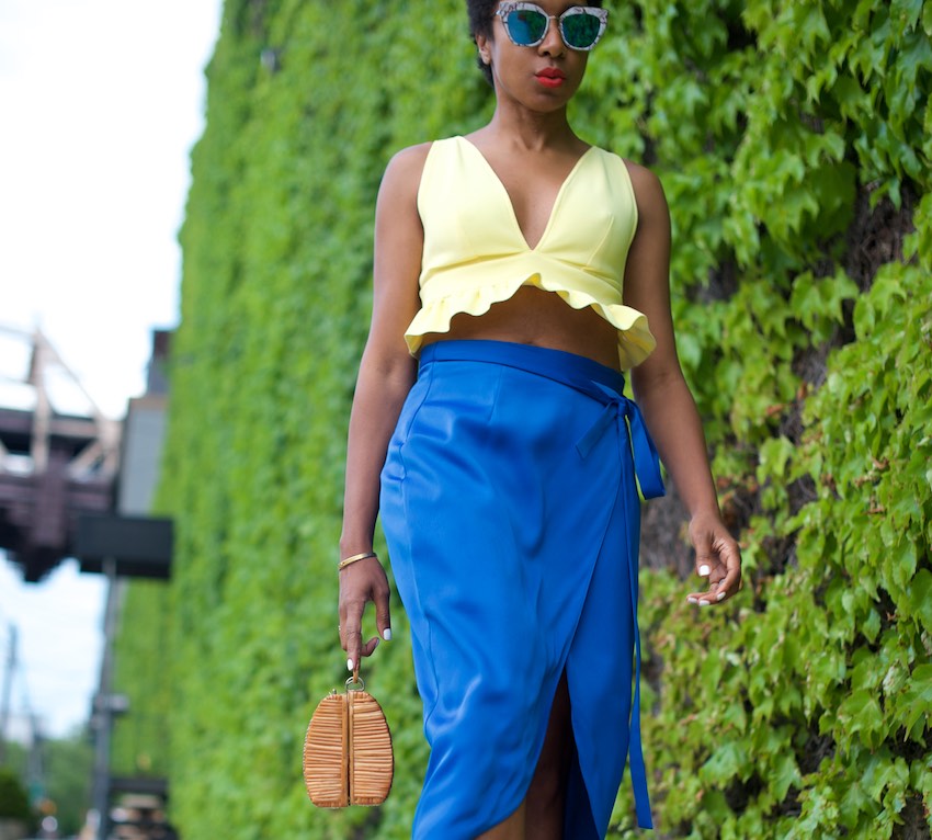 karen blanchard the fashion blogger wearing a yellow bralet top and satin skirt
