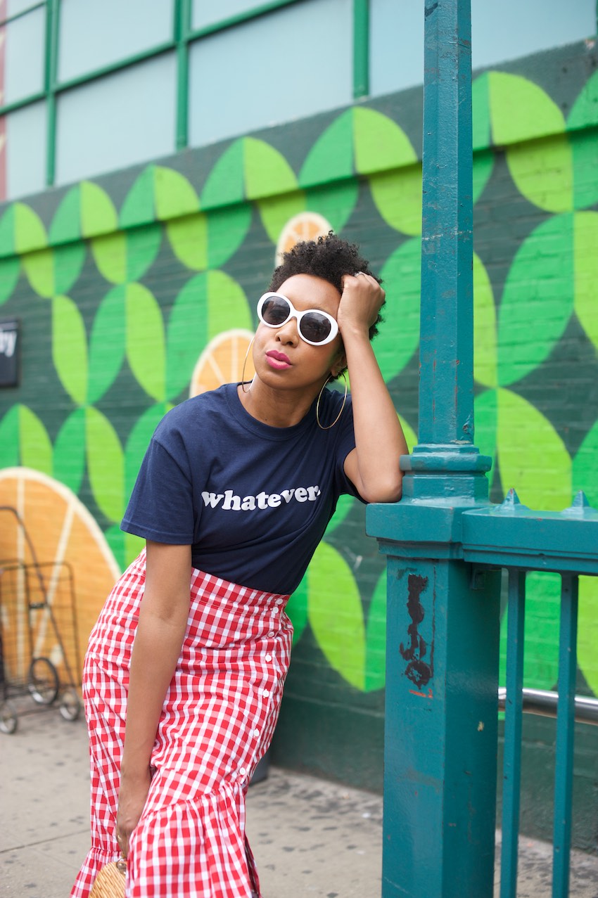 Karen Blanchard the black fashion blogger is wearing a red gingham ruffle skirt with white sunglasses
