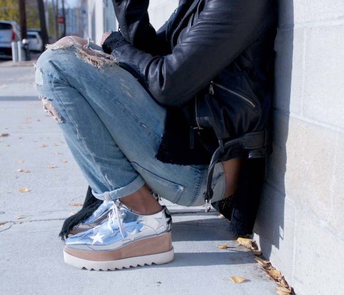 fashion blogger Karen Blanchard wearing stella mccartney platform shoes with a black leather jacket and ripped denim jeans