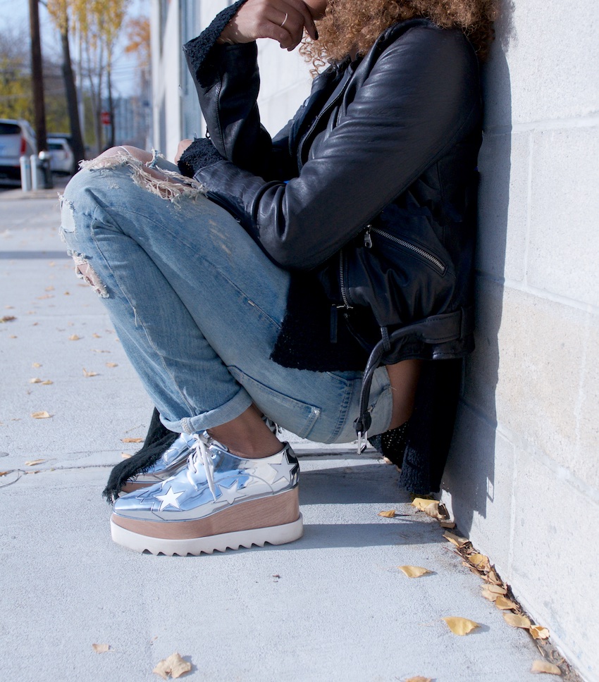 fashion blogger Karen Blanchard wearing stella mccartney platform shoes with a black leather jacket and ripped denim jeans