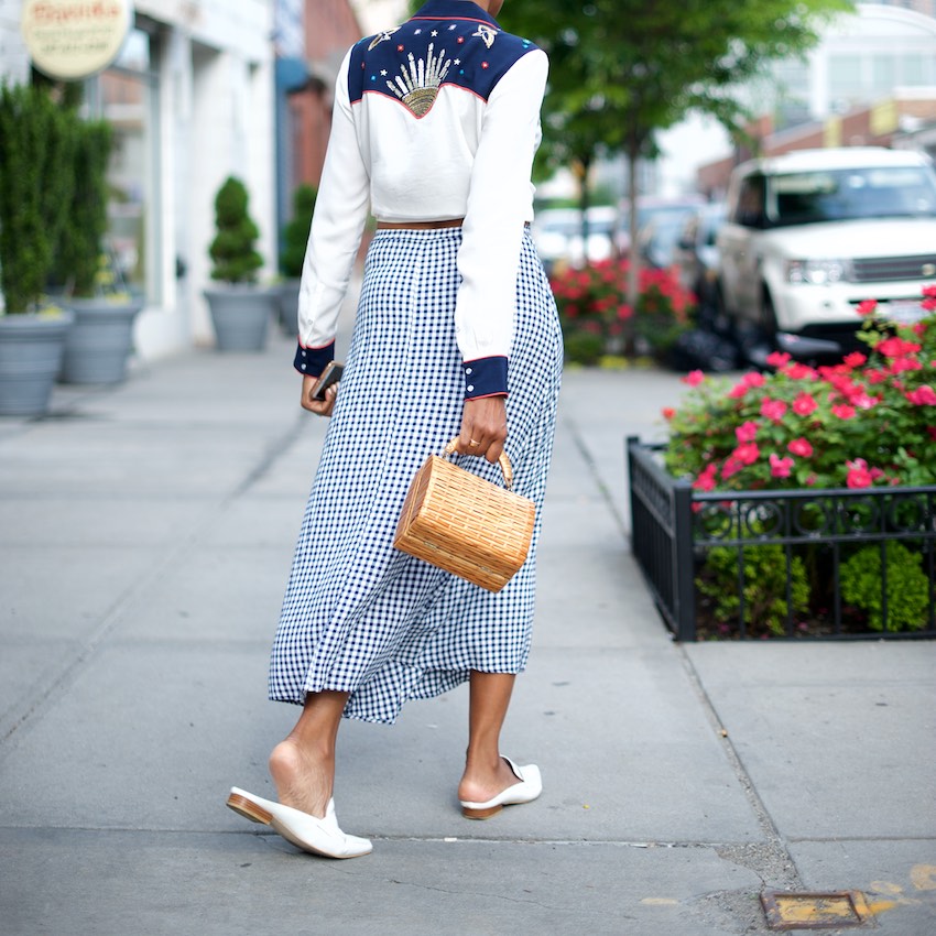 Karen Blanchard is wearing a gingham skirt with a beaded western style shirt and jeffrey campbell mules