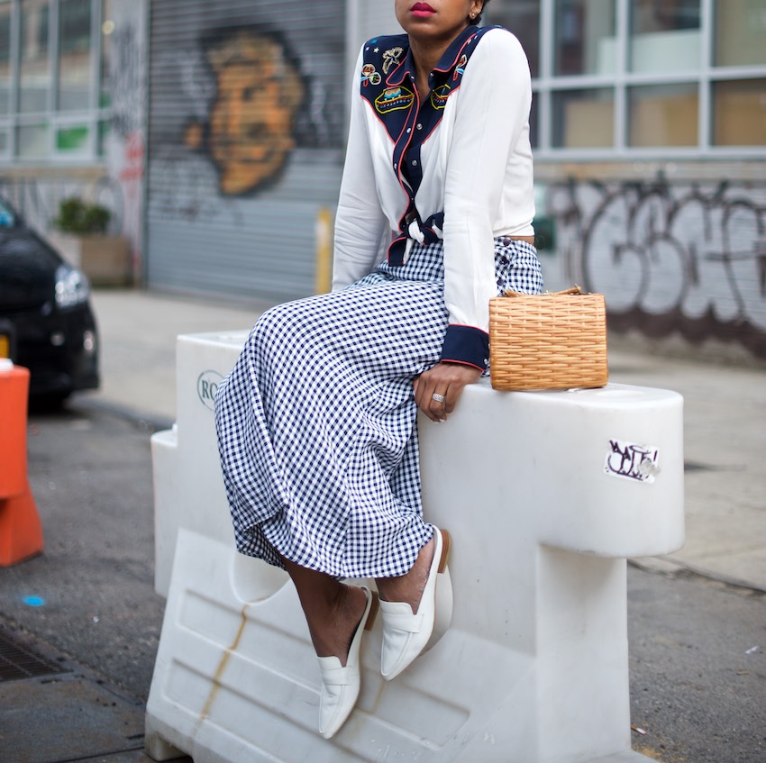 Karen Blanchard is wearing a gingham maxi skirt with a vintage wicker basket bag and white mules