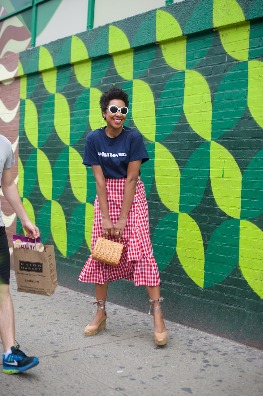 Karen Blanchard is wearing white sunglasses with a gingham ruffle skirt and Castaner espadrilles